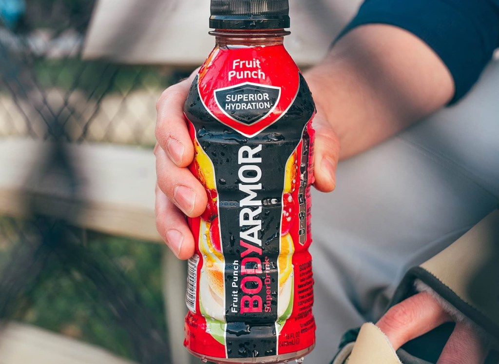 hand holding Body Armor Sports Drink Sports Beverage Fruit Punch