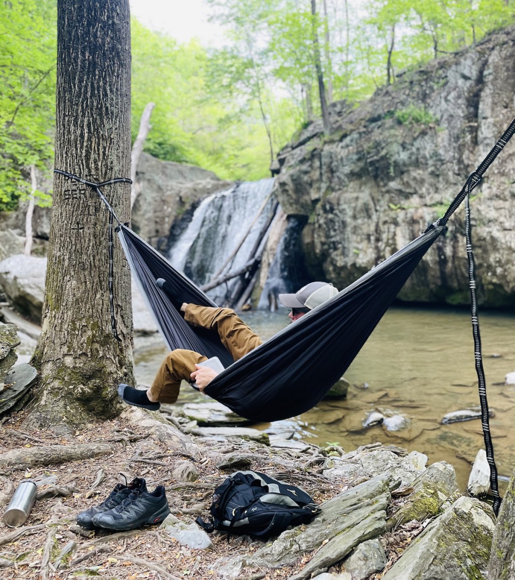 man sitting in hammock hanging from trees - relaxing fathers day gift ideas