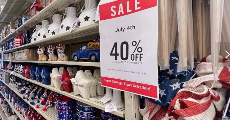 40% off 4th of july sale sign with shelf full of products behind it