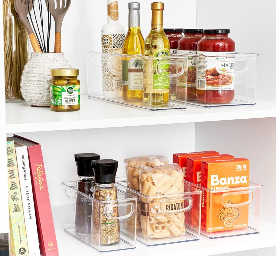 food in clear plastic containers on white shelves