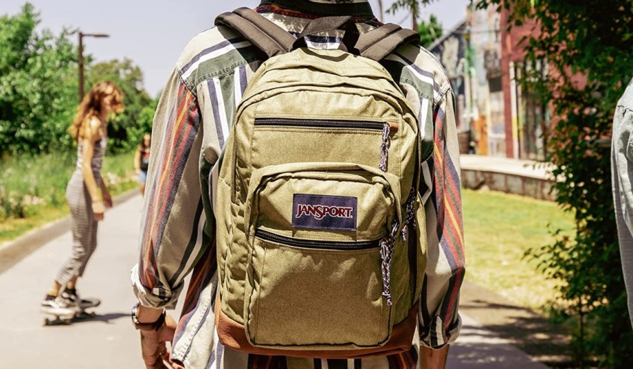 boy wearing tan backpack
