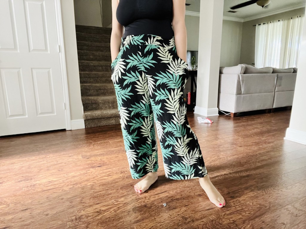 woman posing in palm tree pajama pants 