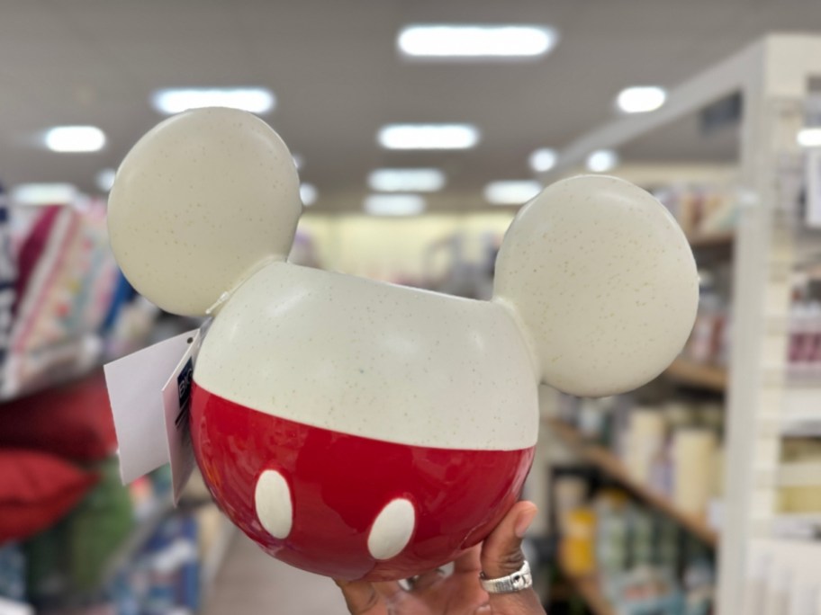 hand holding a white and red Mickey Mouse head shaped ceramic planter