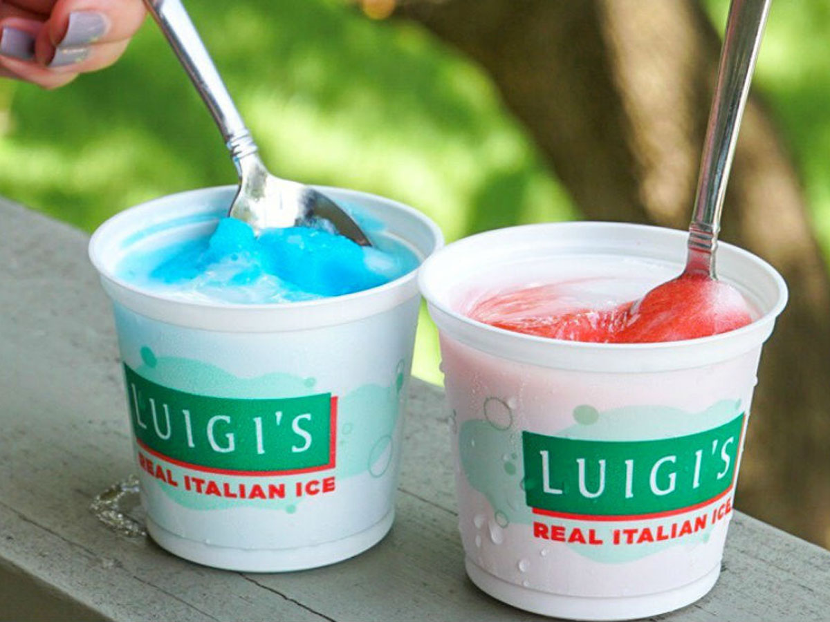 two cups of luigis real italian ice with spoons in them