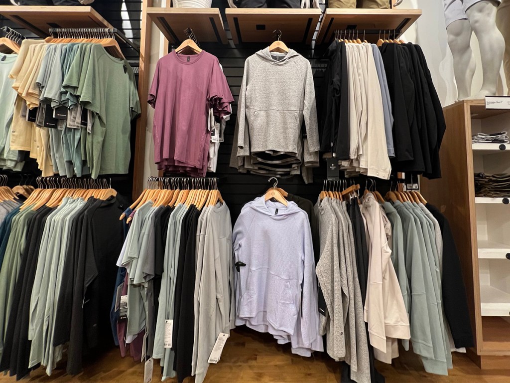 lululemon hoodies hanging on shelves in store