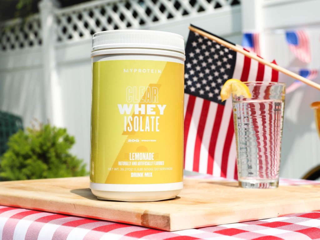 lemonade protein powder jug next to american flag