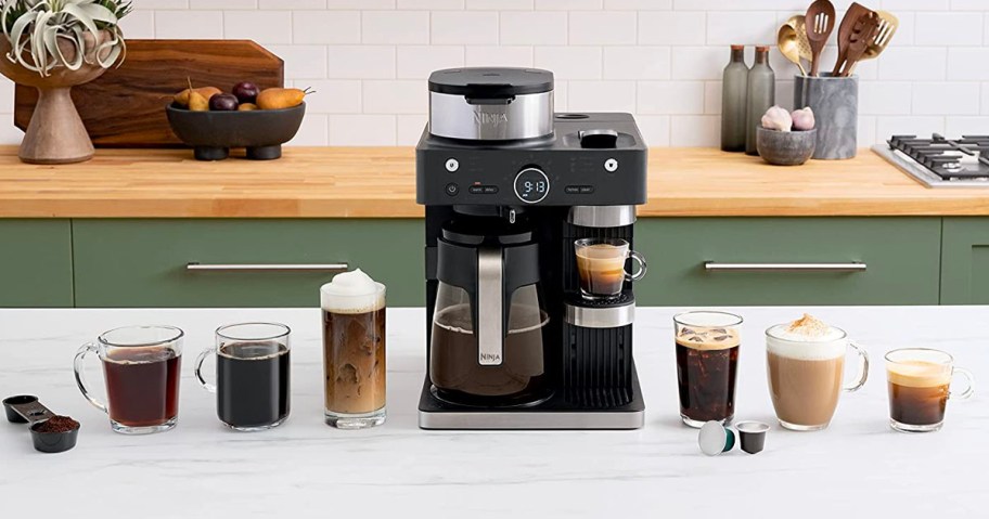 ninja barista coffee system with cups and accessories on counter