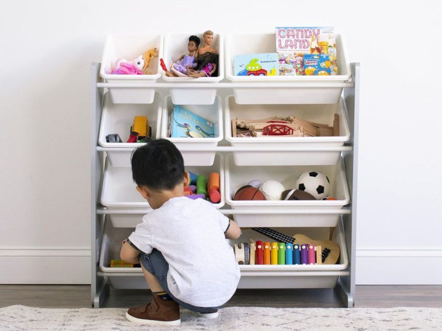 Humble Crew, Grey/White Kids Toy Organizer with 12 Storage Bins with boy crouching in front of it