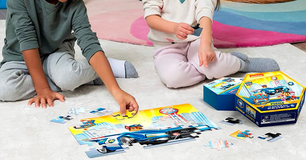 two kids putting together a paw patrol puzzle