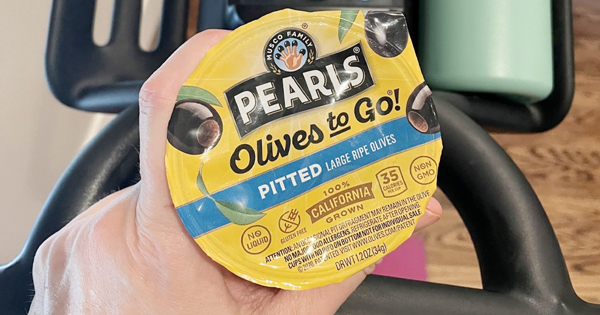 hand holding pearls olives to go cup