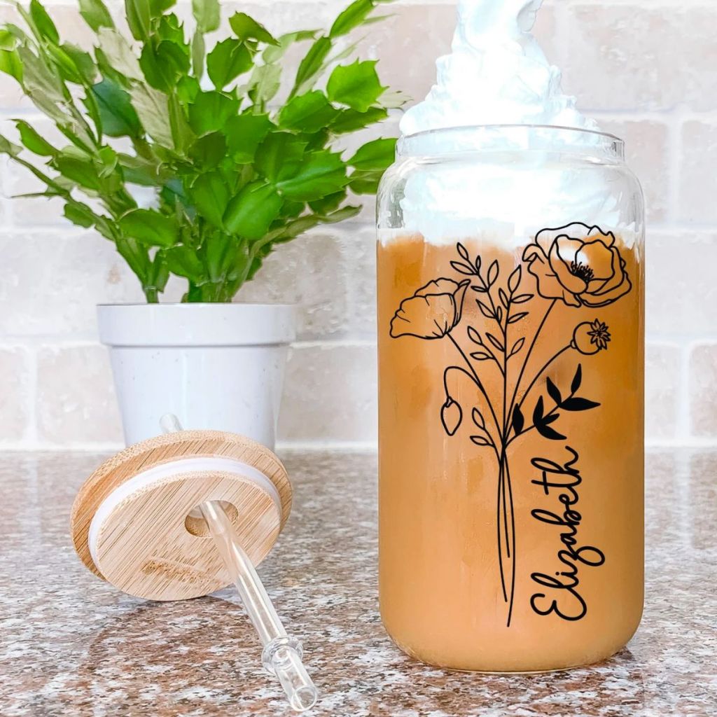personalized coffee tumbler with lid and straw on a kitchen counter 