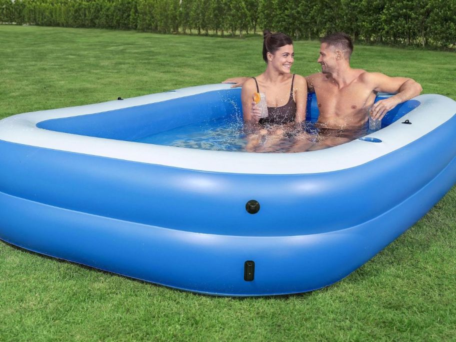 H2GO! Summer Bliss Shaded Inflatable 8ft Family Pool w/ Cupholders with couple in it with shade down