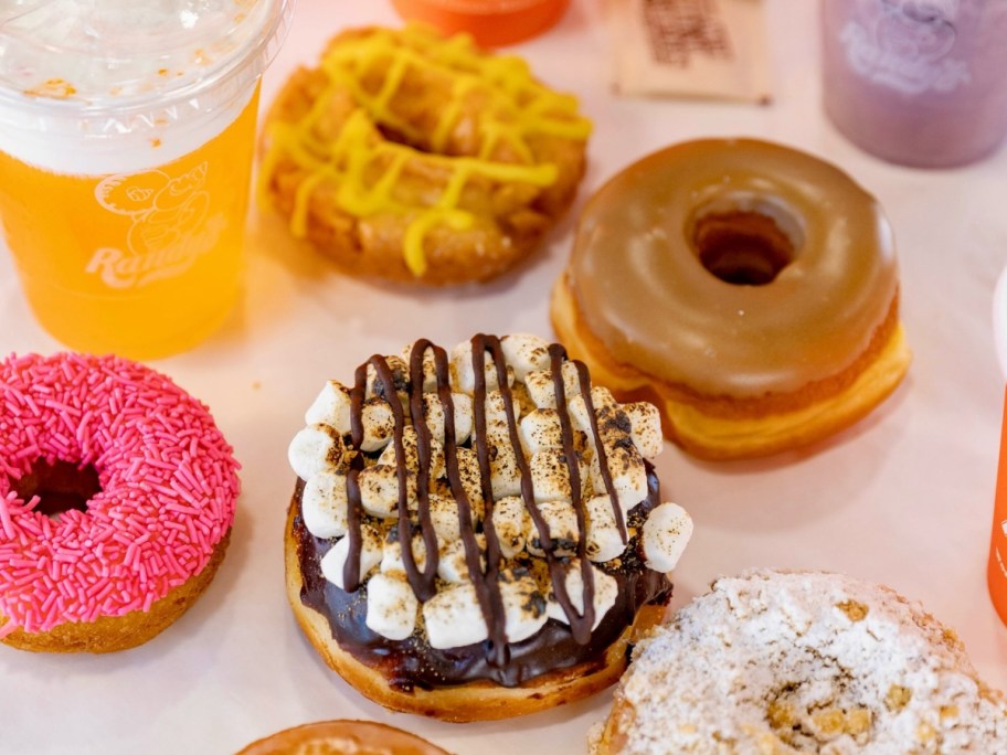 assorted doughnuts next to iced beverages