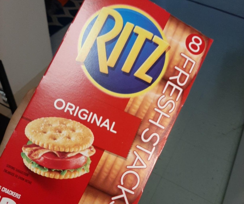 holding a box of Ritz crackers