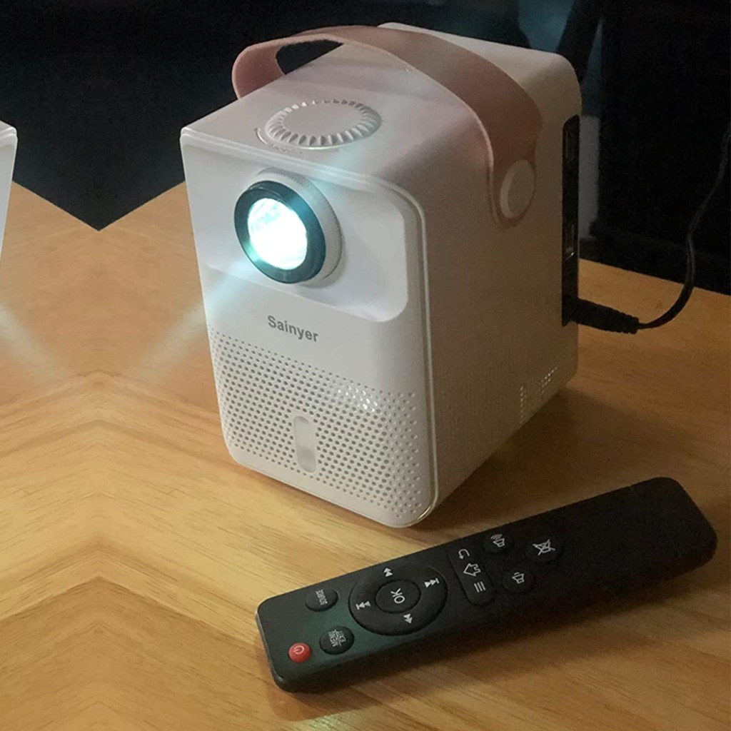 mini white projector with black remote