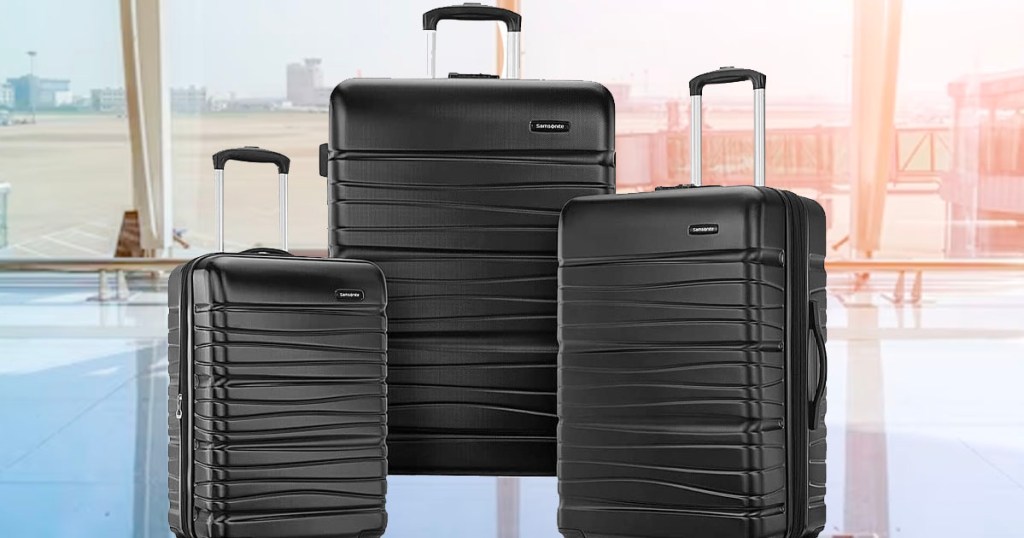 3 piece black luggage set with in airport