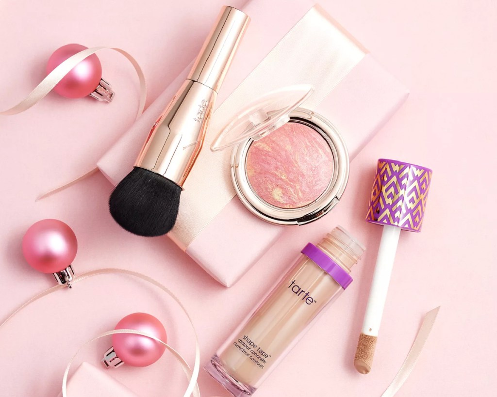 shape tape blush and brush next to pink ornaments