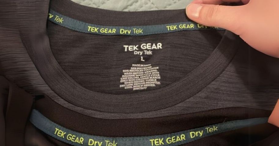 hand touching tek gear men's shirt