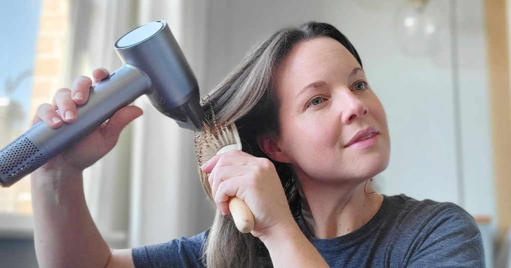 woman using hair dryer