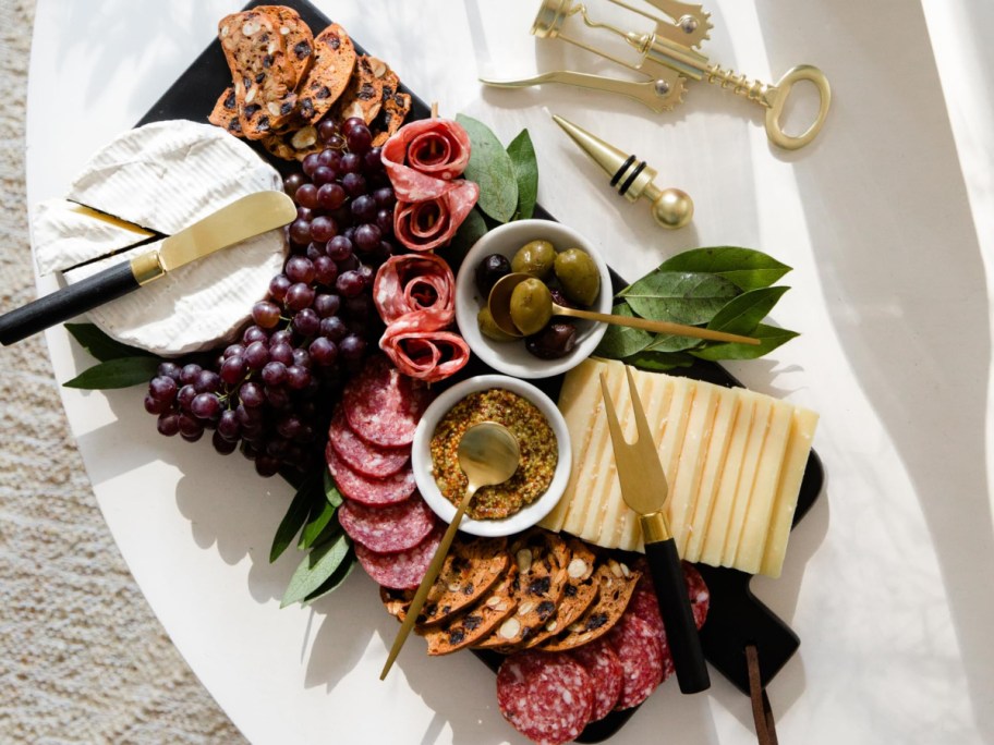 top-down view of a charcuterie board on a white surface