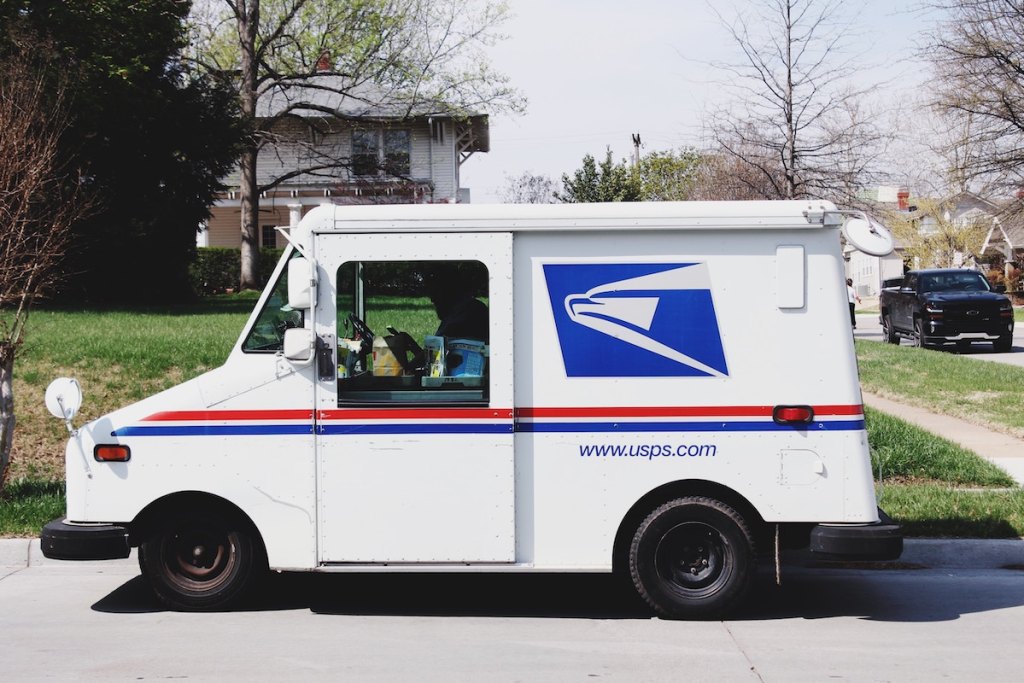 usps mail truck parked on side of street