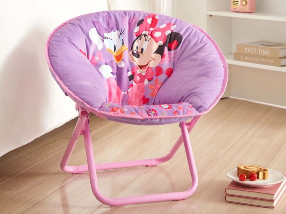 pink and purple Minnie Mouse and Daisy Duck toddler's saucer chair in a bedroom