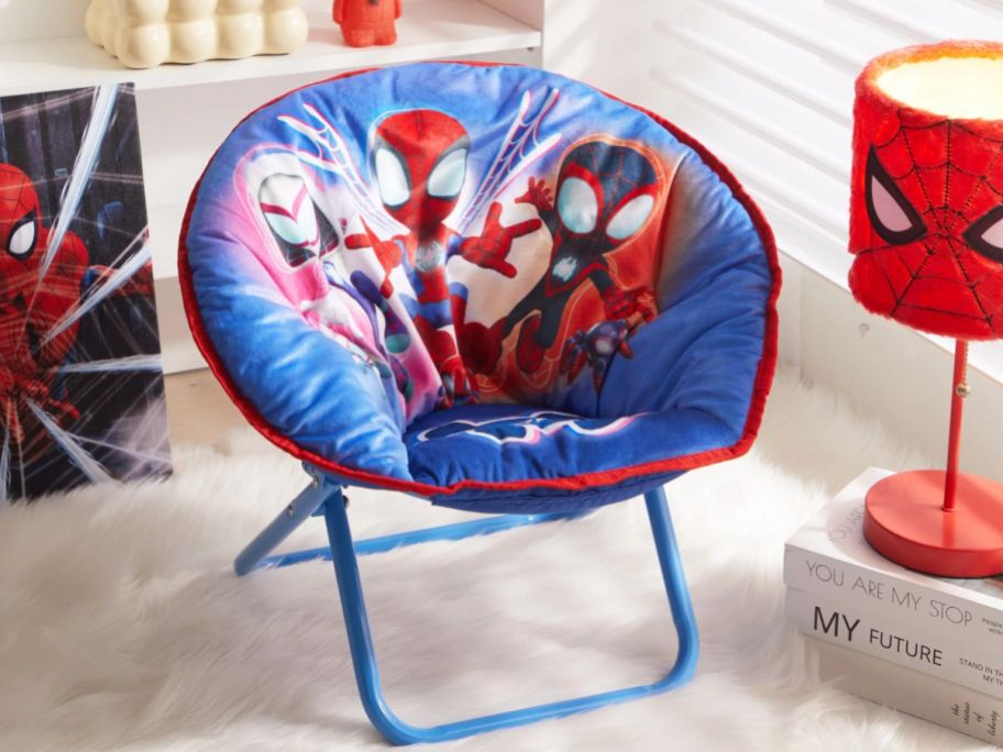 blue Spiderman and friends toddler's saucer chair in a bedroom