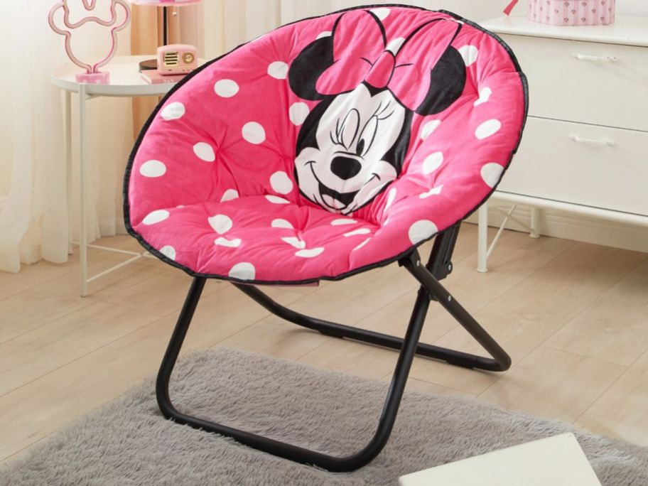 pink and white polka dot Minnie Mouse oversized saucer chair in a bedroom
