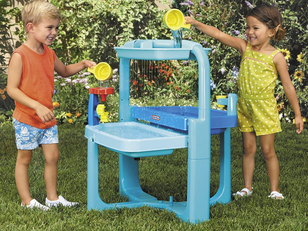 two kids playing at water table