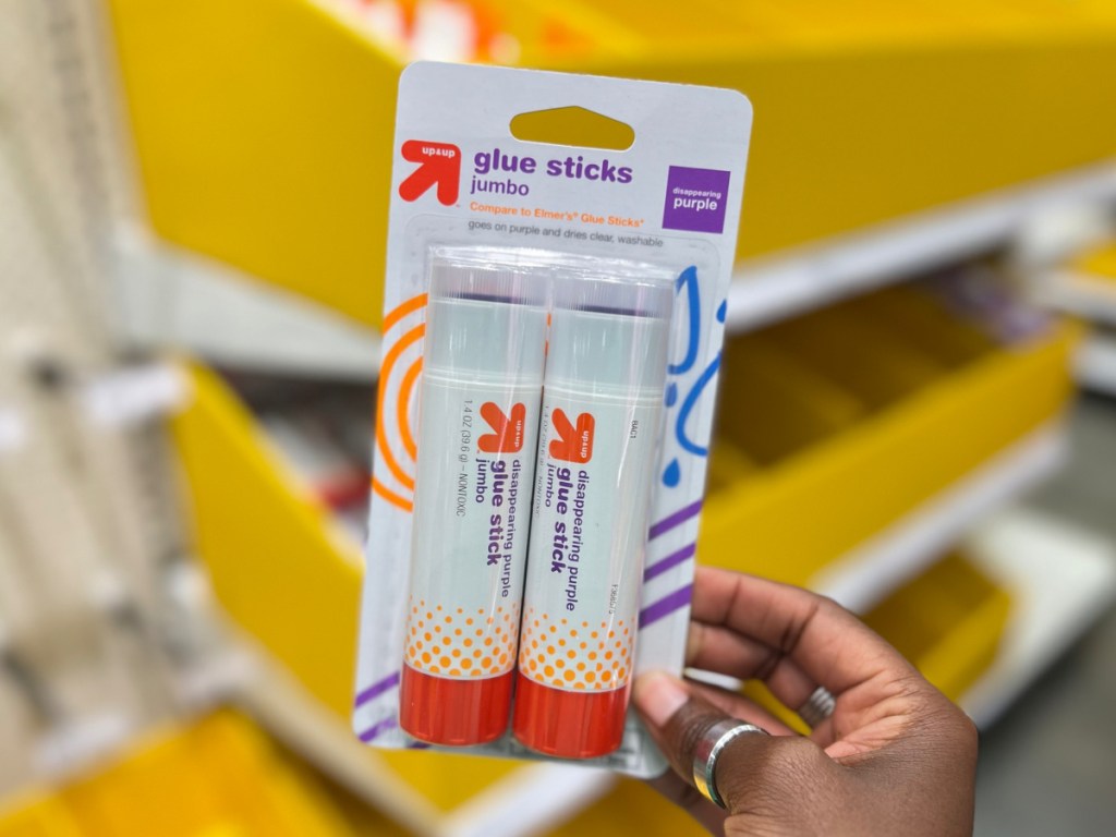 woman holding Disappearing Purple Glue Stick 2-Count