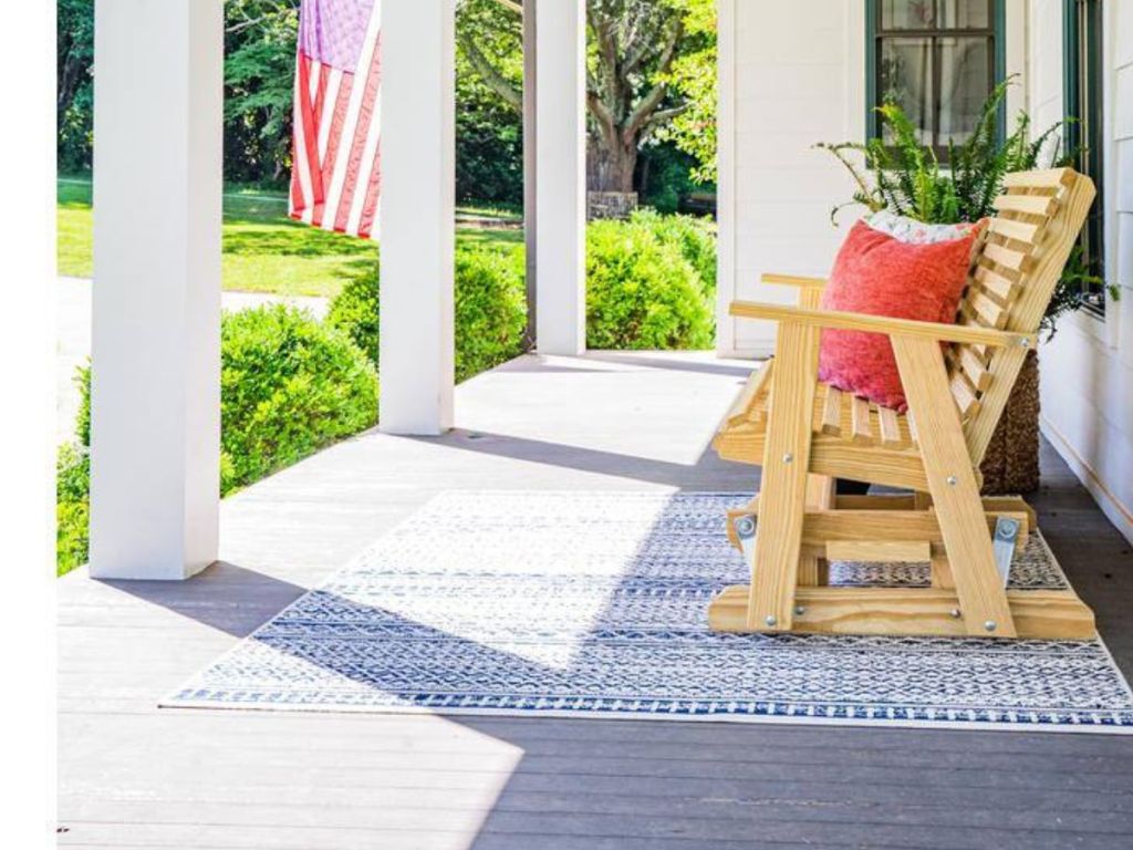 wood slat bench on porch in front of house