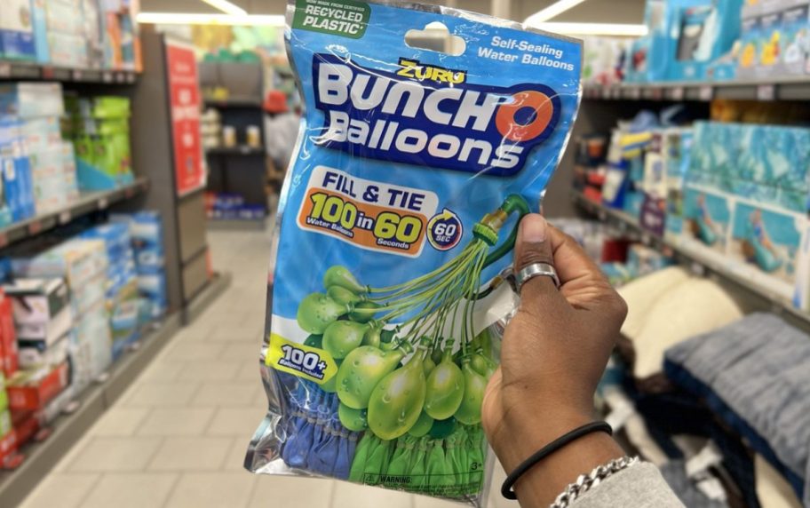 hand holding bunch o balloons water balloon bag