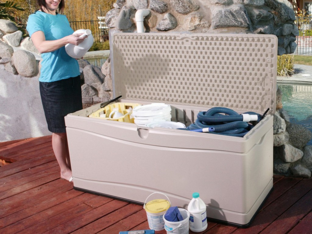 130 gallon storage box filled with pool items and a woman reading a pool liquid level