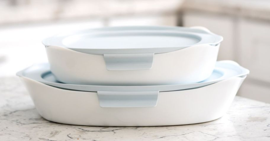white Rubbermaid DuraLite Glass Baking Dishes with blue lids sitting on kitchen counter