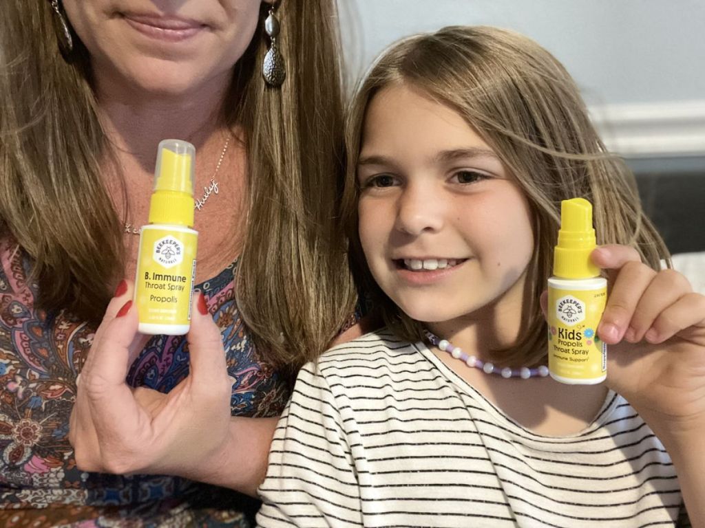 Mother and Daughter shown holding bottles of Beekeeper's Naturals Propolis Throat Sprays