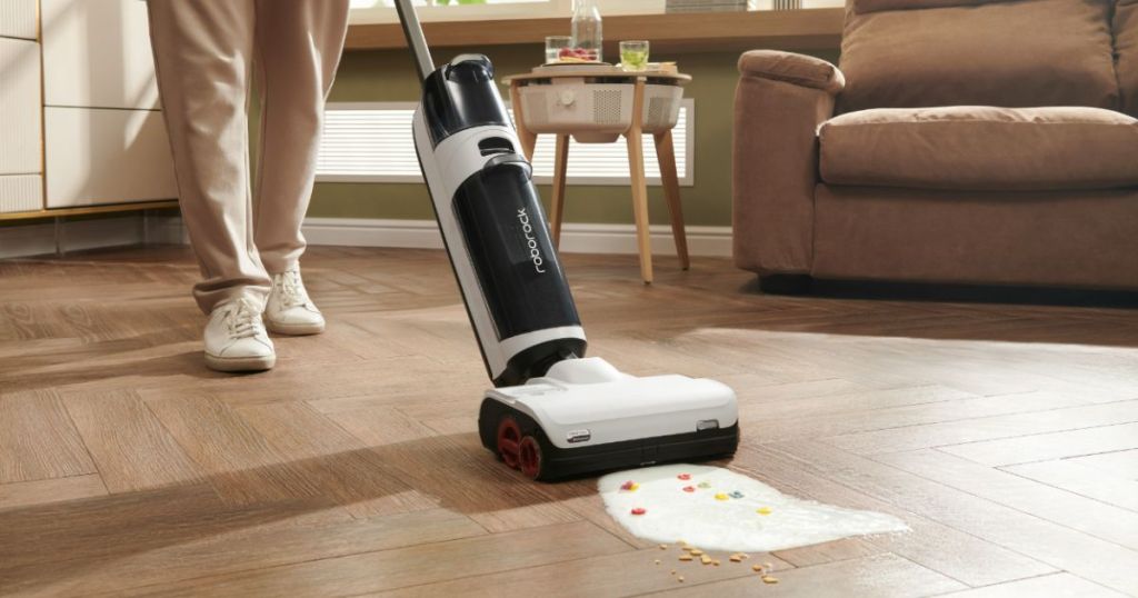 Roborock Dyad Pro Wet and Dry Vacuum Cleaner shown being used to vacuum up spilled mlik