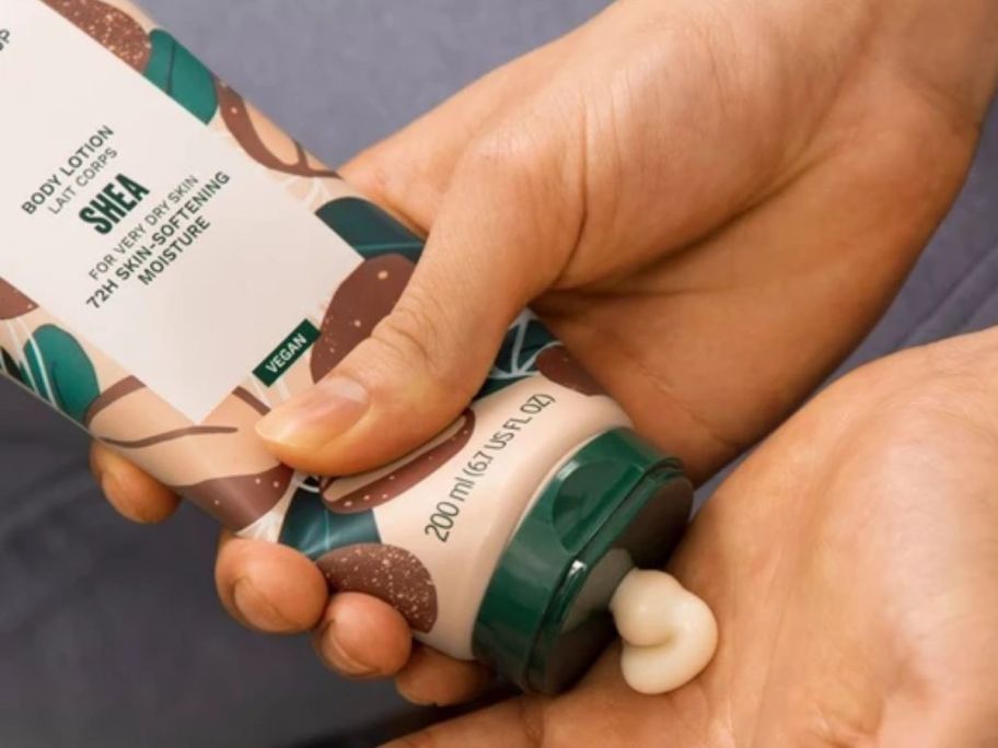 The Body Shop Body Lotion being squeezed onto a hand