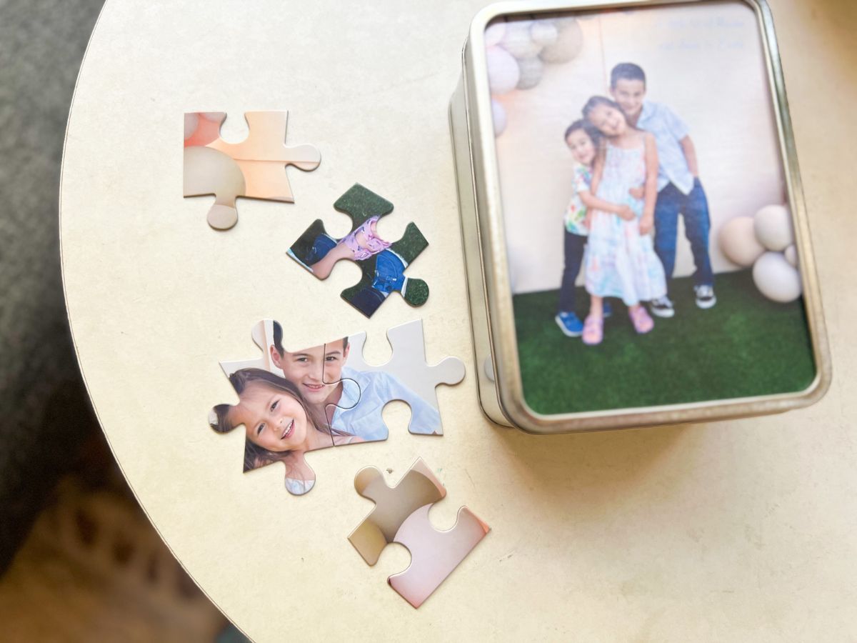 Walgreens Photo Puzzle with pieces shown on table beside of the Keepsake Tin