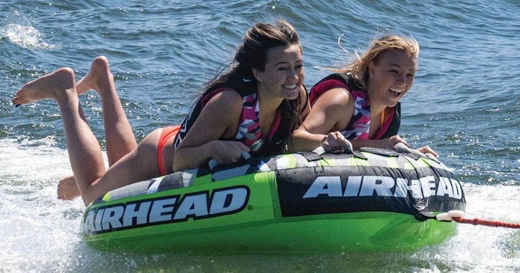 Two girls riding an AIRHEAD Slice, Towable Tube for Boating with 1-4 Rider Options in the water