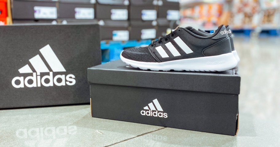 pair of black and white adidas shoes on top of shoe box