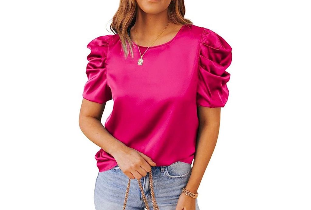 stock photo of woman wearing hot pink blouse with ruffed sleeves
