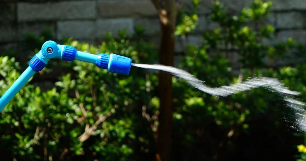 A watering wand spraying water