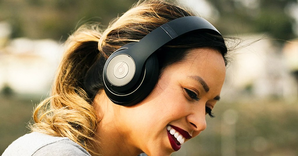 woman wearing pair of black Beats Studio3 Wireless Headphones