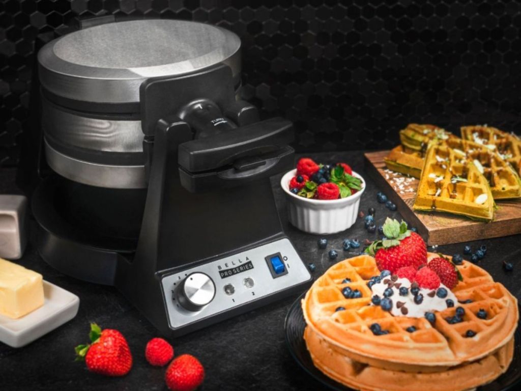 stainless steel bella flip waffle maker with waffles next to it