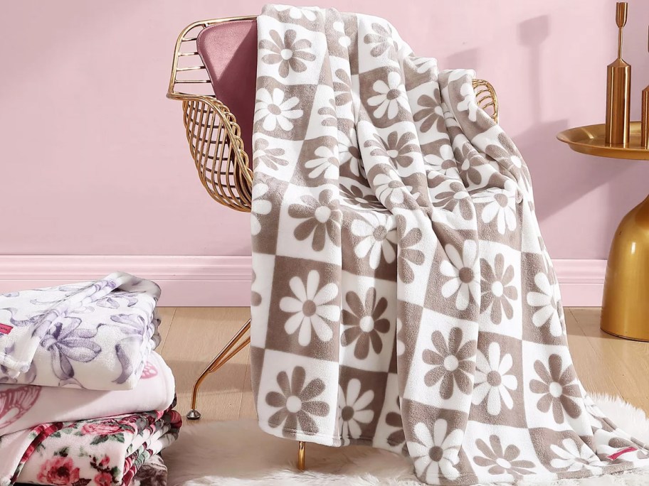 checkered flower print throw draped over a chair