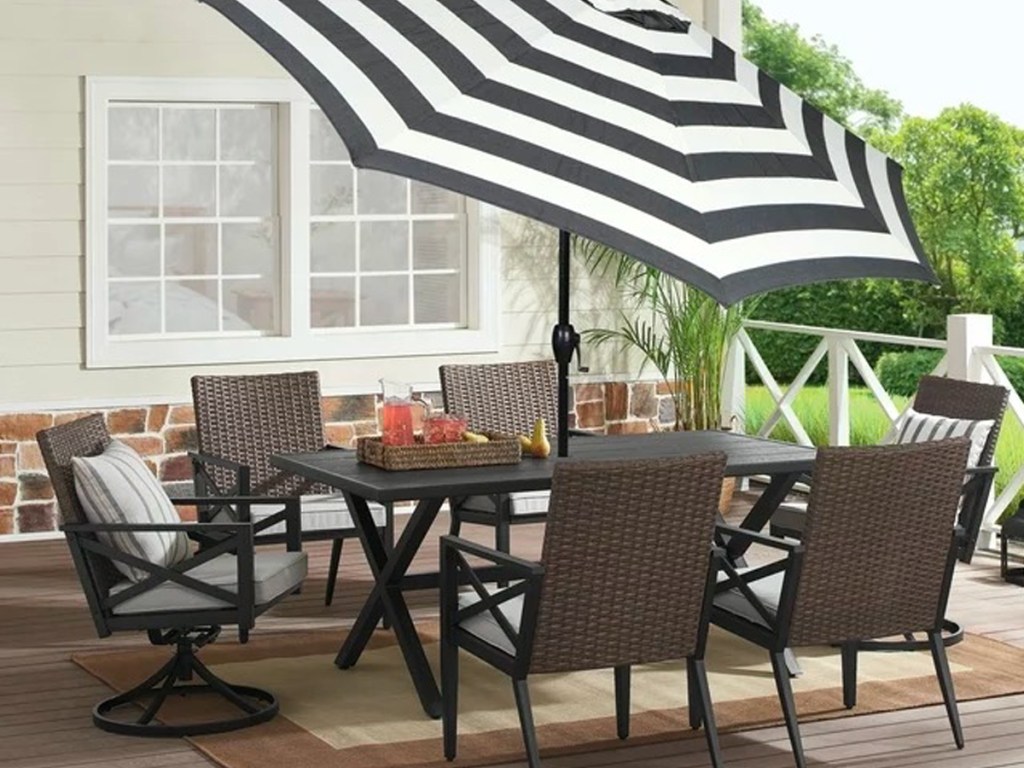Better Homes & Gardens 9ft Round Outdoor Patio Umbrella in Ibiza Stripes on a patio table