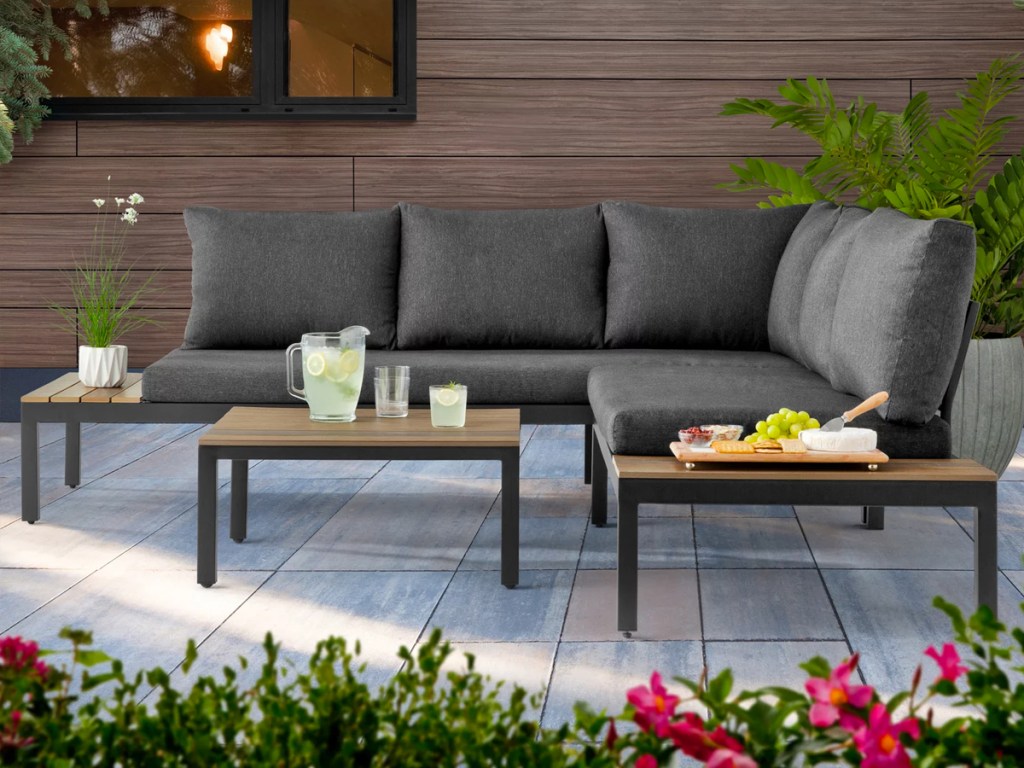 grey patio section with a wood table in center
