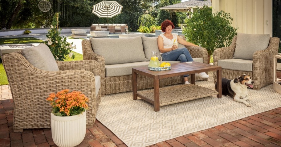 A woman sitting on a patio with a Better Homes and Gardens set