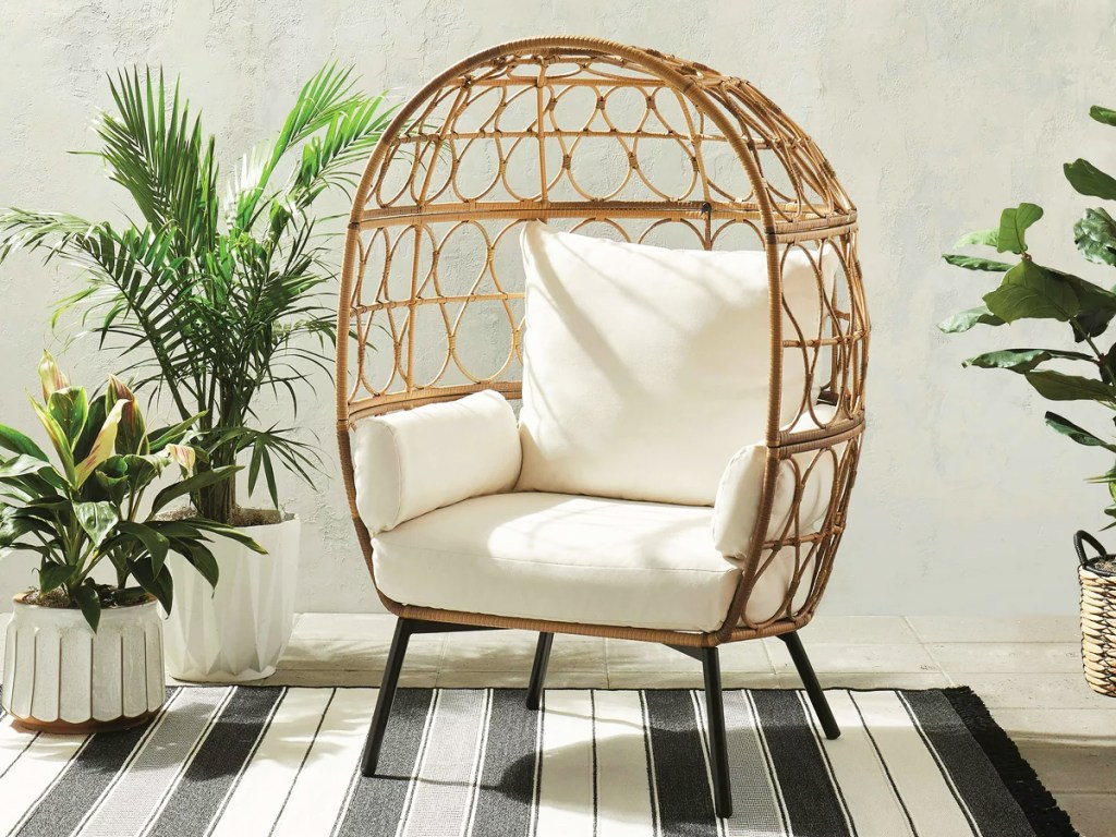 wicker egg chair with white cushions