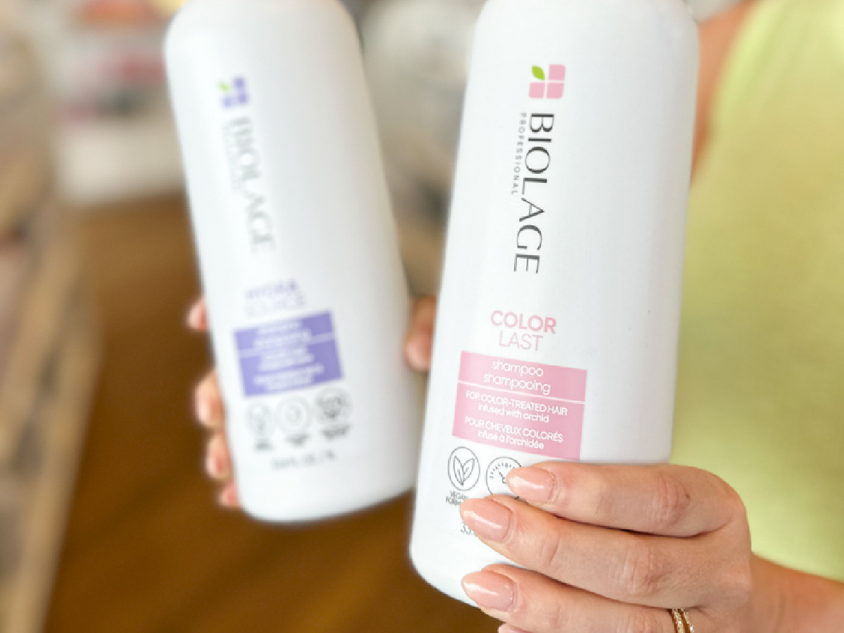 woman holding bottles of biolage hair care